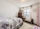 Neutral bedroom with carpet, natural light, dresser and bed with patterned comforter at 1488 W 102Nd Ave, Northglenn, CO 80260