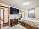 Comfortable bedroom features carpet floors, TV, sliding mirrored closet and natural light at 1488 W 102Nd Ave, Northglenn, CO 80260