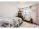 Bright bedroom offers a comfy bed, vintage dresser, and a window with sheer curtains at 1488 W 102Nd Ave, Northglenn, CO 80260