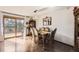 Sunlit dining room featuring hardwood floors, elegant chandelier, and access to the backyard deck at 1488 W 102Nd Ave, Northglenn, CO 80260