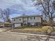 View of a charming two-story home with light gray siding and well-maintained front yard at 1488 W 102Nd Ave, Northglenn, CO 80260