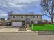 Charming two-story home featuring a well-manicured lawn and attached garage on a sunny day at 1488 W 102Nd Ave, Northglenn, CO 80260