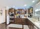 Well-equipped kitchen features stainless steel appliances, custom cabinetry, and stone countertops at 1488 W 102Nd Ave, Northglenn, CO 80260