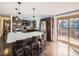 Modern kitchen with stainless steel appliances, island seating, and sliding doors to the deck at 1488 W 102Nd Ave, Northglenn, CO 80260
