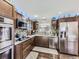 Modern kitchen with stainless steel appliances, custom cabinets, and stylish backsplash at 1488 W 102Nd Ave, Northglenn, CO 80260