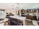 Open kitchen featuring a large island, modern appliances, and seamless flow to the living area at 1488 W 102Nd Ave, Northglenn, CO 80260