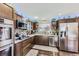 Modern kitchen with stainless steel appliances, beautiful countertops, and ample cabinet space at 1488 W 102Nd Ave, Northglenn, CO 80260