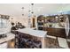 Open kitchen with bar seating overlooking living area, modern appliances, and custom cabinetry at 1488 W 102Nd Ave, Northglenn, CO 80260