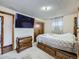 This main bedroom features a wall-mounted television, closet, and under-bed storage drawers for optimal storage solutions at 1488 W 102Nd Ave, Northglenn, CO 80260