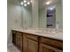 Bathroom with double vanity, marble countertop and wood cabinets at 112 S Holman Way, Golden, CO 80401