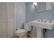 Clean bathroom with pedestal sink, toilet and light blue walls at 112 S Holman Way, Golden, CO 80401