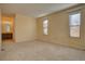 Spacious carpeted bedroom with two windows at 112 S Holman Way, Golden, CO 80401