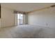 Spacious carpeted bedroom with large window and balcony access at 112 S Holman Way, Golden, CO 80401