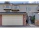 Townhouse exterior with a two-car garage and entrance at 112 S Holman Way, Golden, CO 80401