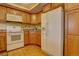 Corner kitchen with white appliances and wood cabinets at 112 S Holman Way, Golden, CO 80401