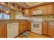 Kitchen with white appliances and wood cabinets at 112 S Holman Way, Golden, CO 80401