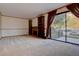 Living room with fireplace, built-in shelving, and patio access at 112 S Holman Way, Golden, CO 80401