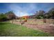 Well-maintained backyard with tiered retaining walls and diverse plantings, offering a tranquil setting at 1562 Madison Ct, Louisville, CO 80027