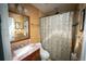 A bathroom with wood vanity, granite top, mirror and decorative shower curtain at 1562 Madison Ct, Louisville, CO 80027