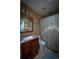 A bathroom featuring a decorative shower curtain, vanity, mirror, and tile flooring at 1562 Madison Ct, Louisville, CO 80027