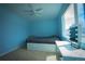 A bedroom with blue walls, carpet, large windows, and modern vanity at 1562 Madison Ct, Louisville, CO 80027