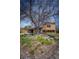 Charming home with rock garden, mature tree in yard, driveway, and a brick and siding exterior at 1562 Madison Ct, Louisville, CO 80027
