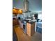 An open kitchen with stainless steel stove and hood, granite countertops and steps to the living room at 1562 Madison Ct, Louisville, CO 80027