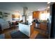 An open kitchen with a center island, wood cabinets, stainless appliances, and dining area at 1562 Madison Ct, Louisville, CO 80027