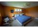 A main bedroom with carpet, warm colored walls, ceiling fan, and a decorative sitting area at 1562 Madison Ct, Louisville, CO 80027