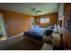 A spacious main bedroom with warm-toned walls, carpet, fan and closet at 1562 Madison Ct, Louisville, CO 80027
