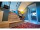 Stylish stairway with wooden steps, a colorful rug, and a glimpse into the adjacent bathroom at 1562 Madison Ct, Louisville, CO 80027
