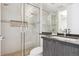 Bright bathroom featuring a glass enclosed shower, modern vanity, and tiled floors at 1201 N Williams St # 3A, Denver, CO 80218