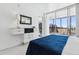 Bright bedroom featuring a king bed, an attached balcony, and a modern dresser at 1201 N Williams St # 3A, Denver, CO 80218