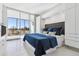 Bright bedroom featuring a king bed, an attached balcony, and ample built in closet space at 1201 N Williams St # 3A, Denver, CO 80218