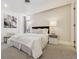 Bedroom with plush white carpet, king bed, and modern art at 1201 N Williams St # 3A, Denver, CO 80218