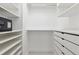 Bright walk in closet with built in organization and shelving in a neutral color palette at 1201 N Williams St # 3A, Denver, CO 80218
