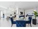 Open-concept dining area with a modern table, leading into a bright living space and kitchen at 1201 N Williams St # 3A, Denver, CO 80218
