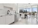 Modern kitchen featuring white cabinets, stainless steel appliances, and a view of the patio for indoor/outdoor living at 1201 N Williams St # 3A, Denver, CO 80218