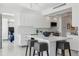 Modern kitchen featuring white cabinetry, an island with seating, and direct access to the bedroom at 1201 N Williams St # 3A, Denver, CO 80218