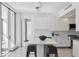 Bright, minimalist kitchen with sleek white cabinets, a quartz countertop island, and modern lighting fixtures at 1201 N Williams St # 3A, Denver, CO 80218