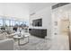 Open-concept living room with a large window, sleek furniture, and view of greenery at 1201 N Williams St # 3A, Denver, CO 80218