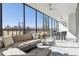 Inviting enclosed patio featuring comfortable seating, dining area, and expansive windows with scenic outdoor views at 1201 N Williams St # 3A, Denver, CO 80218