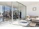 Well-lit enclosed patio showcasing comfortable furniture, a dining set, and seamless access to the interior living spaces at 1201 N Williams St # 3A, Denver, CO 80218