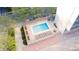 Aerial view of a building's outdoor pool with lounge chairs and landscaping at 1201 N Williams St # 3A, Denver, CO 80218