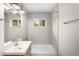 Updated bathroom features neutral tile surround, vanity and tub with shower at 1035 S Garfield St, Denver, CO 80209
