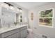 Bright bathroom with a double sink vanity, white countertops and marble tile floors at 1035 S Garfield St, Denver, CO 80209