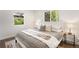 Cozy bedroom with hardwood floors, a plush bed, and ample natural light at 1035 S Garfield St, Denver, CO 80209