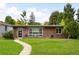 Charming single-story brick home with a well-manicured lawn and walkway to the front door at 1035 S Garfield St, Denver, CO 80209