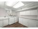 The laundry room features a sink, washer and dryer and built-in storage cabinets at 1035 S Garfield St, Denver, CO 80209