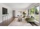 Bright living room with hardwood floors, large window, and stylish furniture at 1035 S Garfield St, Denver, CO 80209